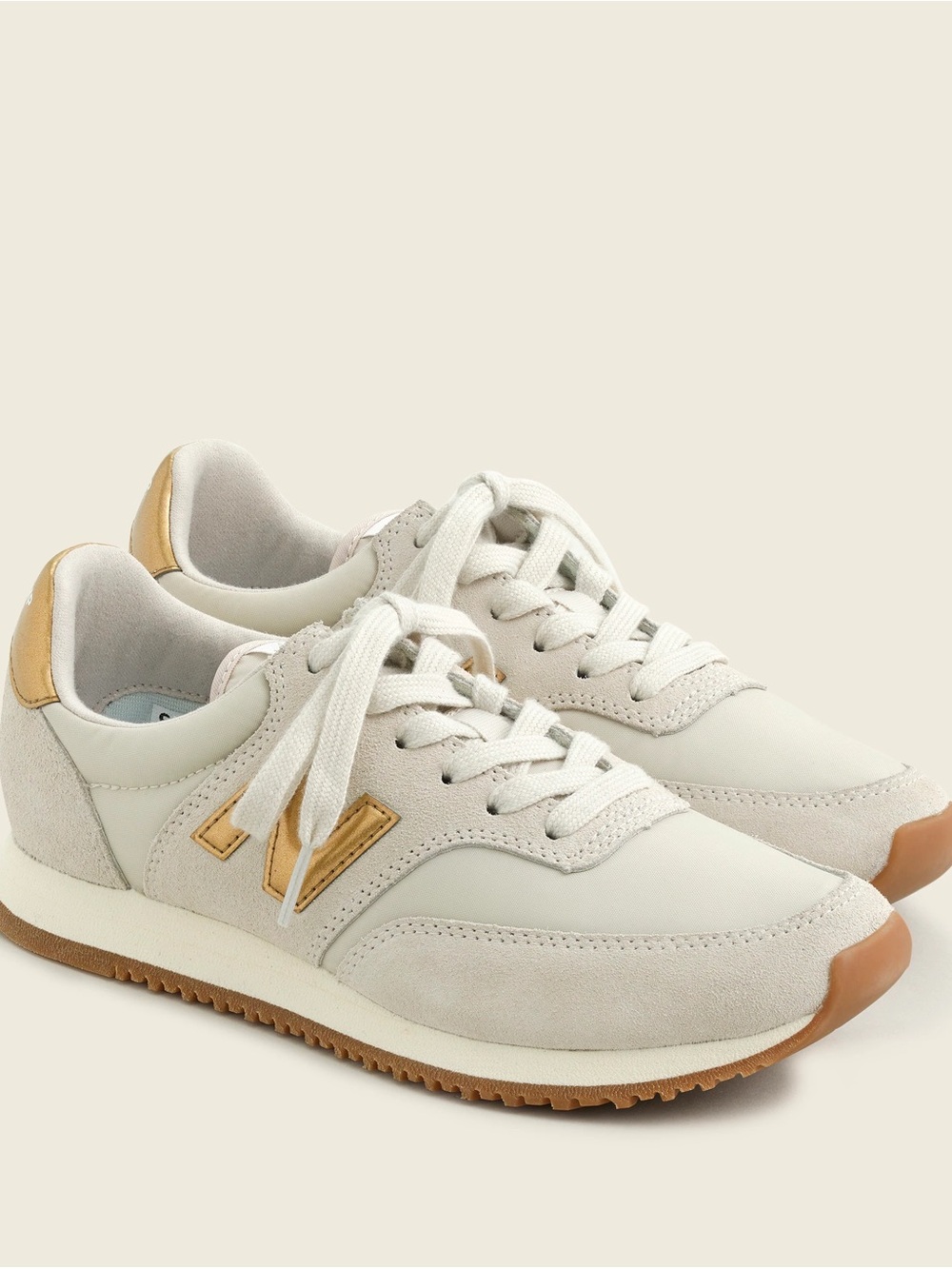 New Balance Women’s Cream Sneakers with Gold Accents
